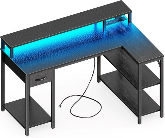 SUPERJARE 47-inch L-shaped gaming desk with LED lights, power outlets, shelves, monitor stand, and drawer, black