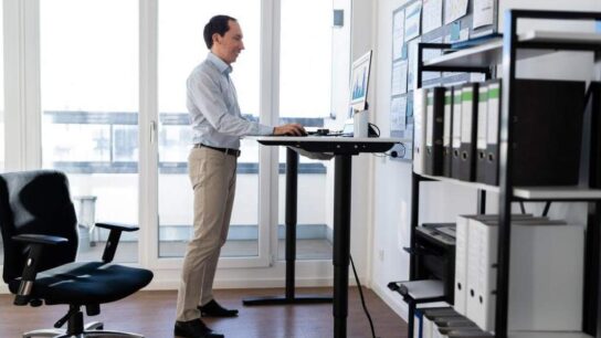 Adjustable sit stand desk in modern home office setup