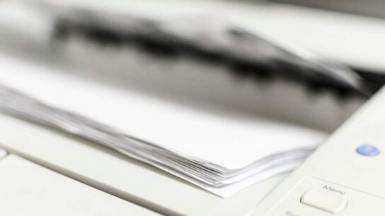 High quality printer paper stack on office desk with printed documents