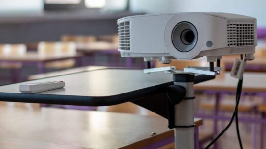 Modern video projector at business conference or lecture in office
