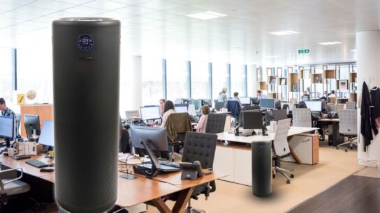 Compact air purifier placed in office room improving indoor air quality